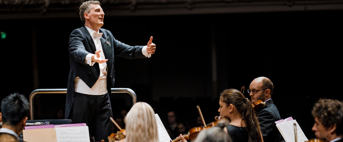 Conductor in front of orchestra band 