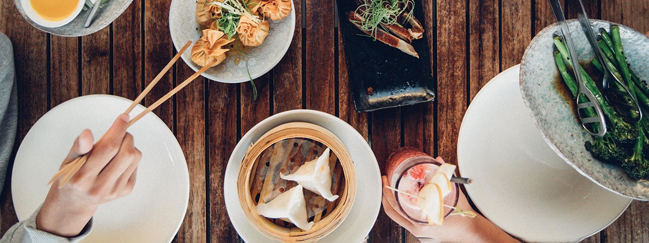 Close up of dumplings and greens at a restaurant