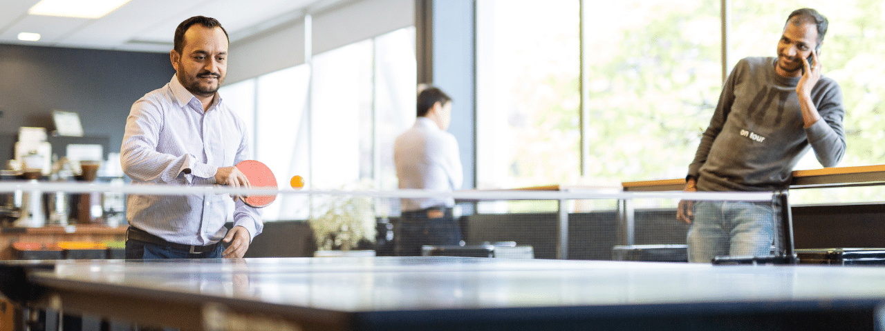 Person playing table tennis in an office