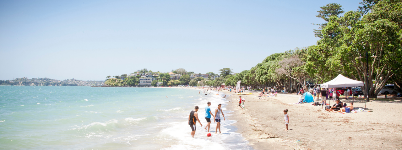 Beach scene of people playing in the water on a summers day