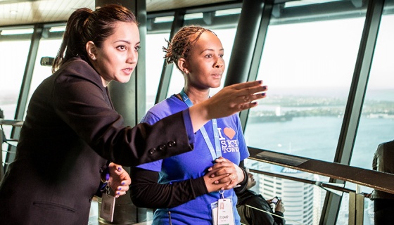 A young person working as a visitor guide at the Sky Tower